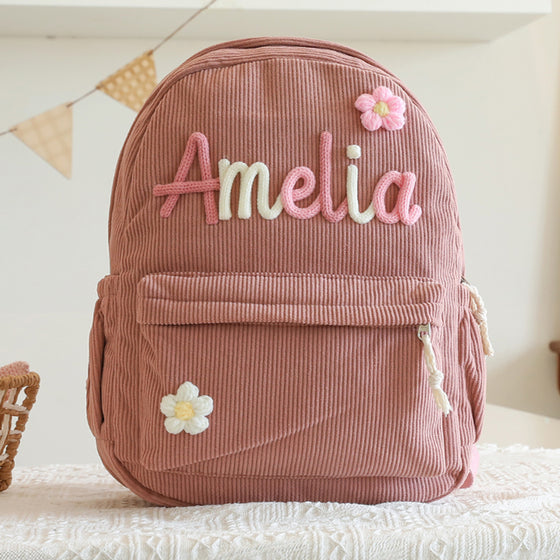 Dusty rose backpack with a knitted name